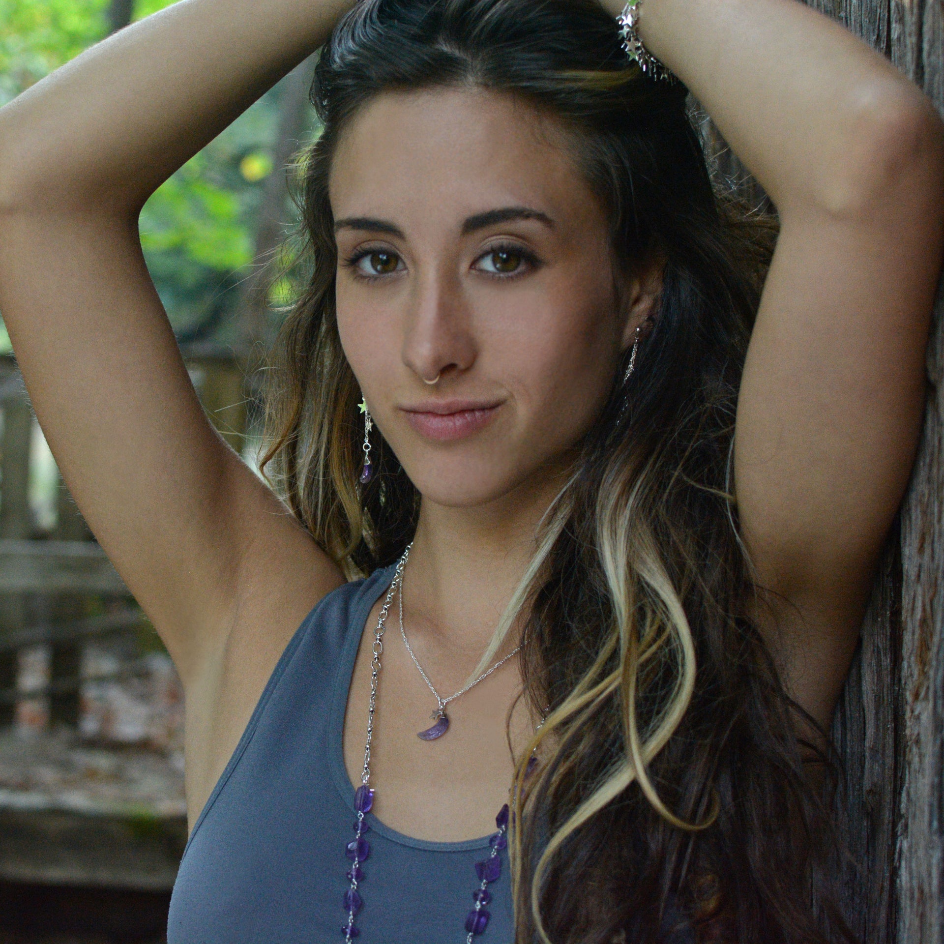 A Long Bohemian Beaded Necklace featuring Faceted Amethyst gemstones on a wire-wrapped chain, paired with an artisanal Silver plated chain, handmade by Tribe Jewelry Designer Sarah Lewis. 