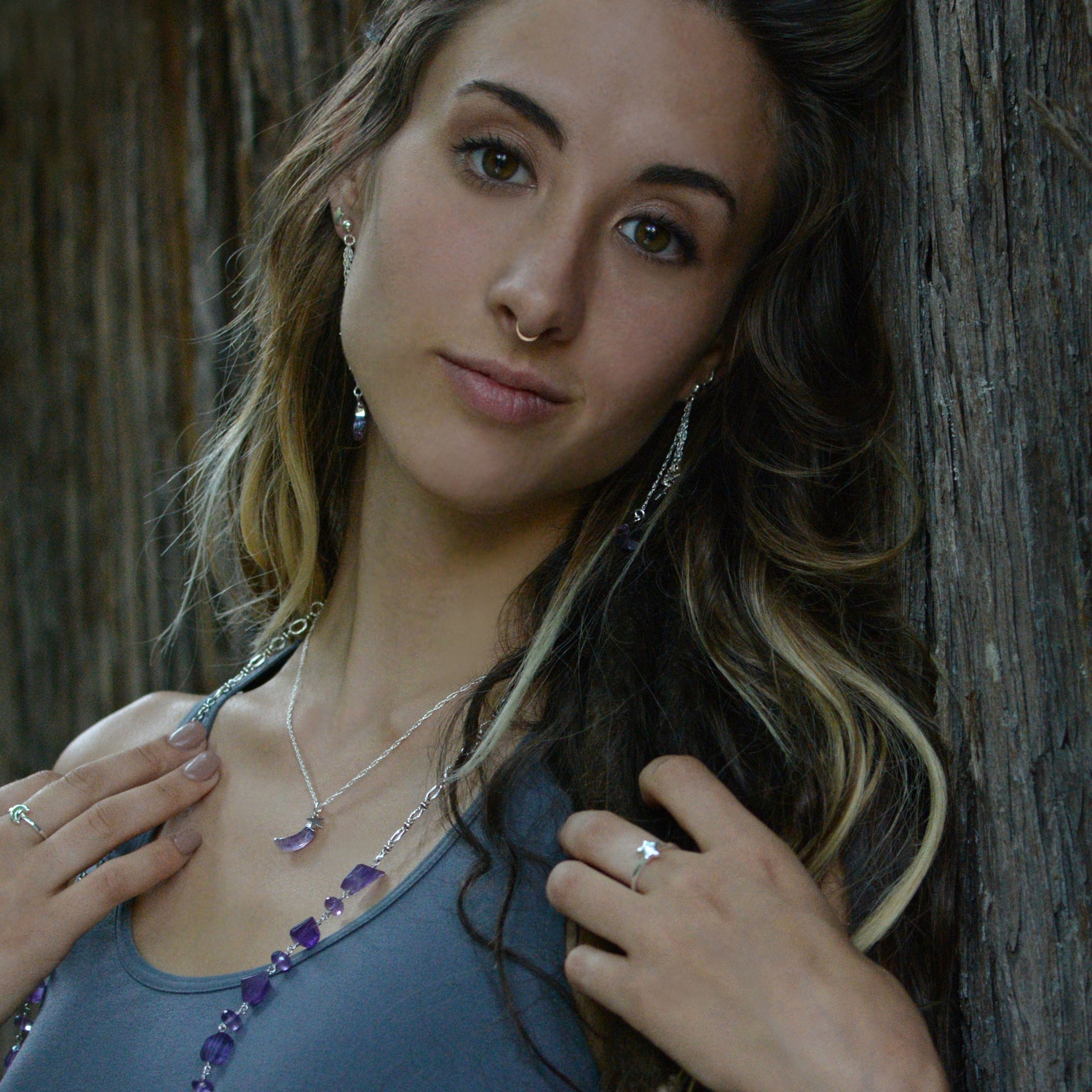 A Long Bohemian Beaded Necklace featuring Faceted Amethyst gemstones on a wire-wrapped chain, paired with an artisanal Silver plated chain, handmade by Tribe Jewelry Designer Sarah Lewis. 