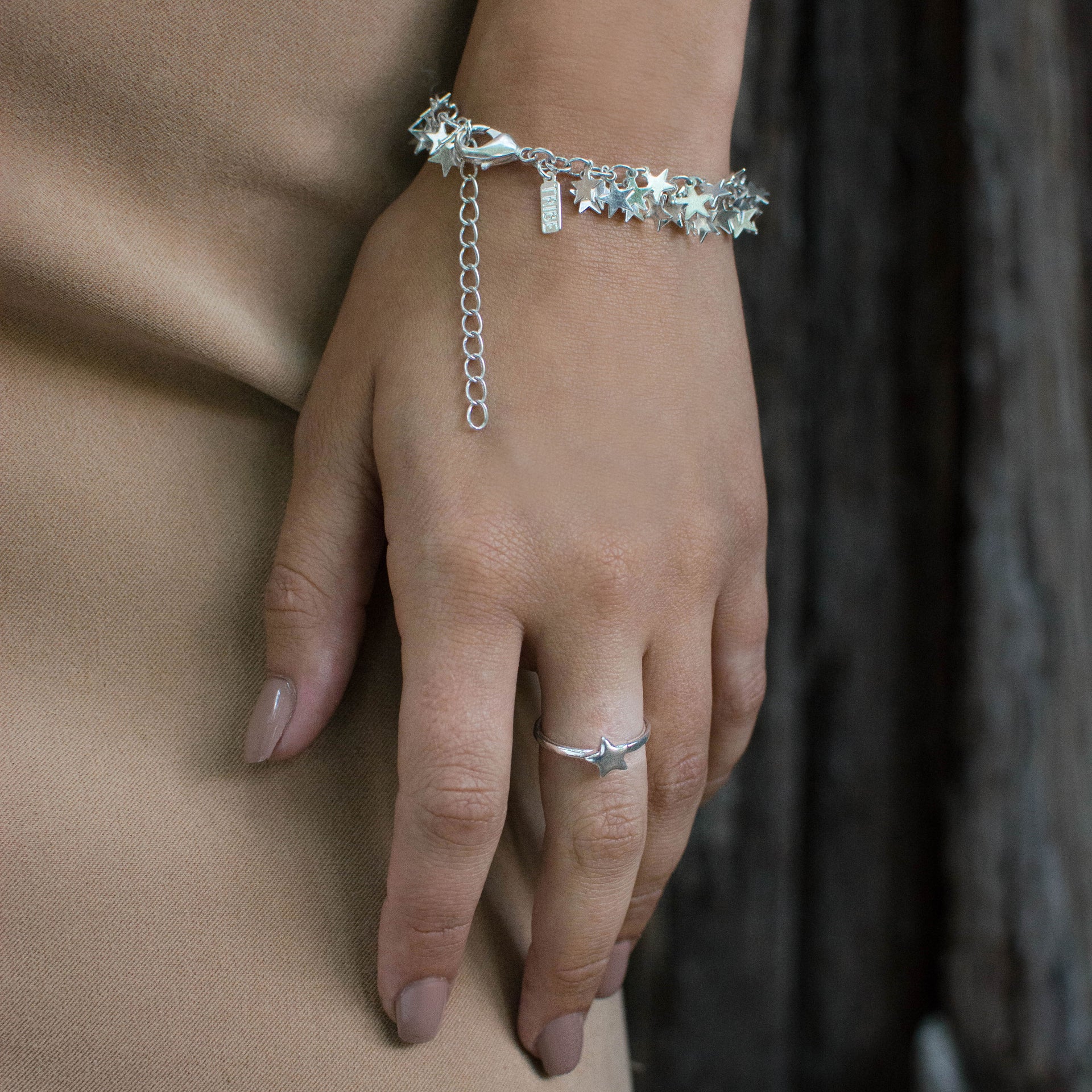 A bohemian style, silver plated stacking ring featuring a tiny star on a hammered band, by Tribe Jewelry Designer Sarah Lewis.