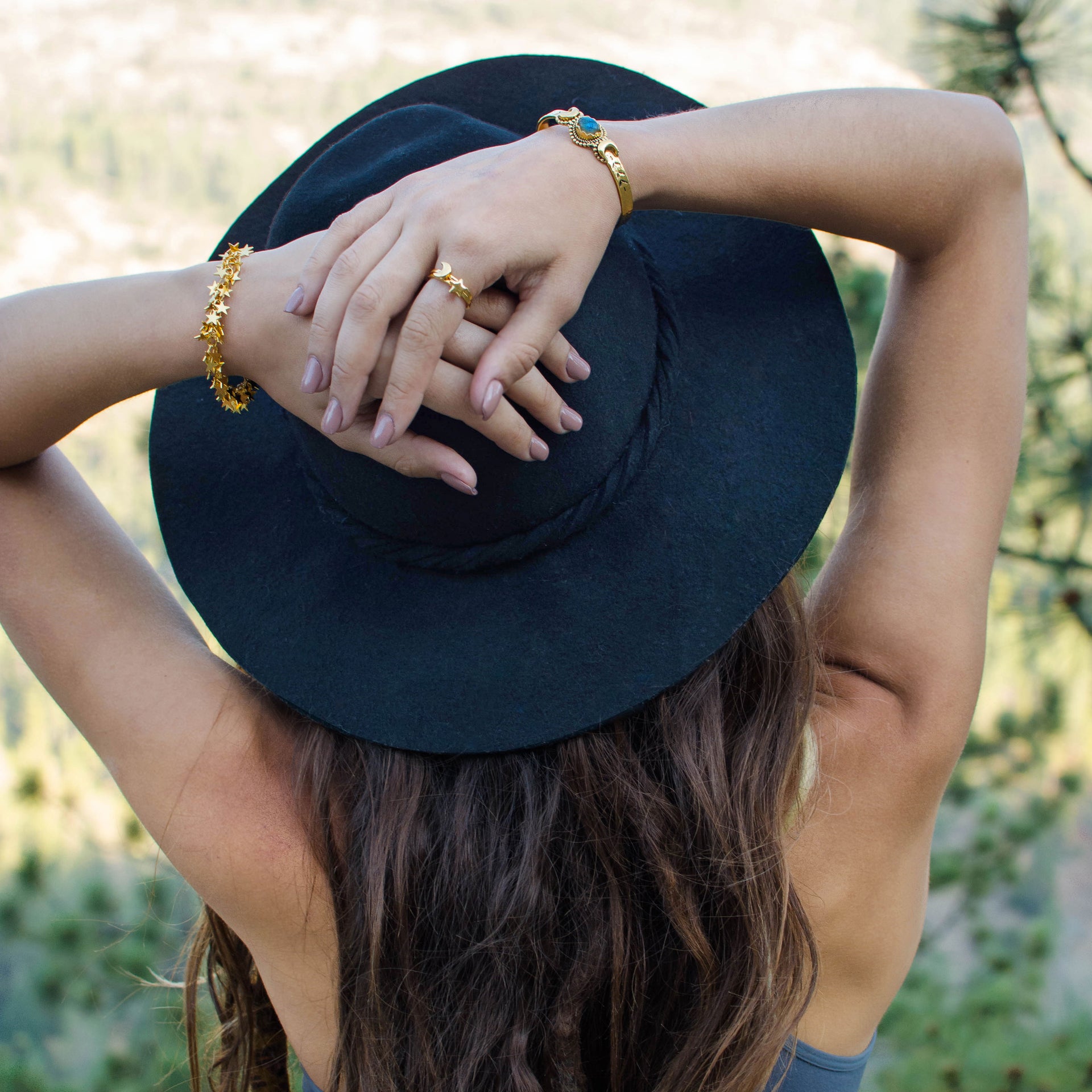 A bohemian style, gold plated stacking ring featuring a tiny star on a hammered band, by Tribe Jewelry Designer Sarah Lewis.