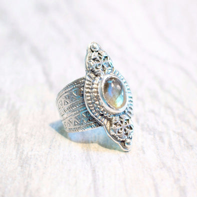 A one of kind ring featuring a faceted labradorite stone set in sterling silver, with snowflake and carved geometric design handmade by Tribe Jewelry Designer Sarah Lewis.