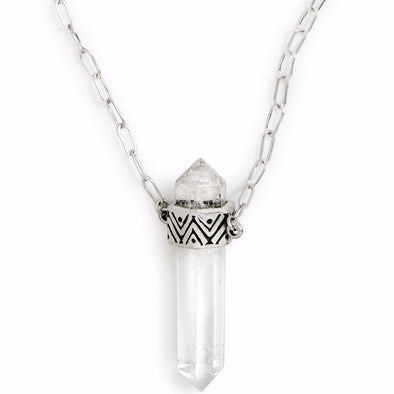 A Sterling Silver Necklace, featuring a Quartz Crystal Pendant with carved geometric pattern on setting. 