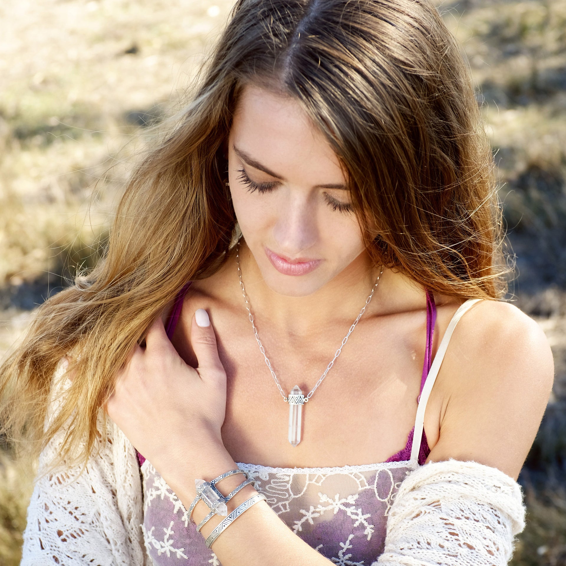 A Sterling Silver Necklace, featuring a Quartz Crystal Pendant with carved geometric pattern on setting. 