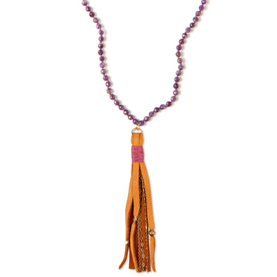 A Bohemian Mala style Necklace featuring a soft Suede Tassel, hanging from a strand of faceted Amethyst gemstone beads, handmade by Tribe Jewelry Designer Sarah Lewis. 