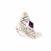 A bohemian style statement ring featuring an amethyst stone set in sterling silver, with carved geometric sri yantra design, by Tribe Jewelry Designer Sarah Lewis.