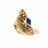 A bohemian style statement ring featuring a lapis lazuli stone pyramid set in gold plated brass, with carved geometric sri yantra design, by Tribe Jewelry Designer Sarah Lewis.