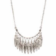 A Bohemian style Necklace features a fringe of feathers hanging on Sterling Silver chain, handmade by Tribe Jewelry Designer Sarah Lewis. 