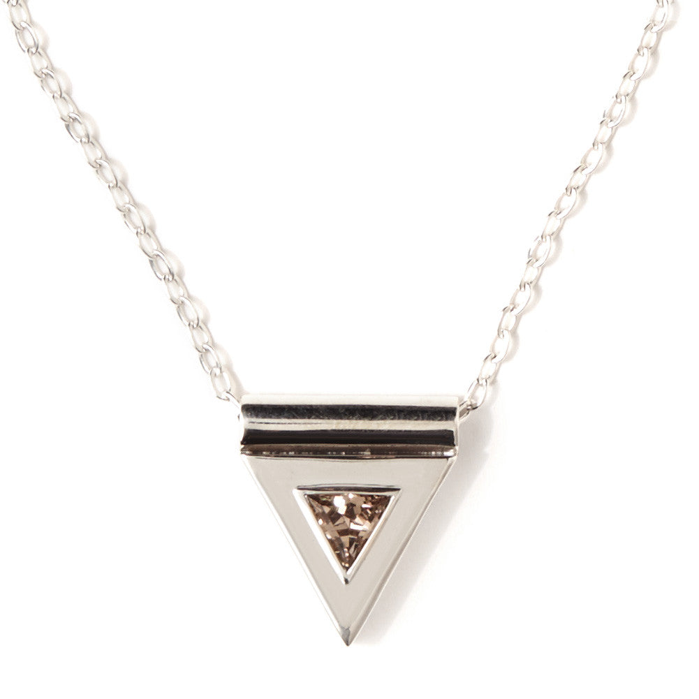 A sterling silver necklace, featuring a faceted, smokey quartz gemstone, in a triangular pendant, handmade by Tribe Jewelry Designer Sarah Lewis.