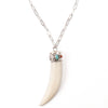 A Bohemian style Necklaces featuring a carved bone claw Pendant, set in a Sterling Silver end cap, with Turquoise and Coral stones, hanging on a long silver chain, handmade by Tribe Jewelry Designer Sarah Lewis. 